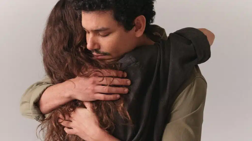 A man hugging a woman.