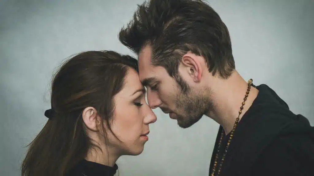 A couple touching foreheads and having a tender moment.