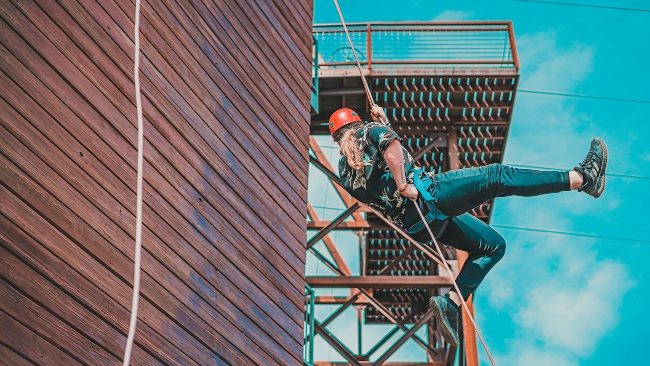 A man climbing up the side of a tall building.