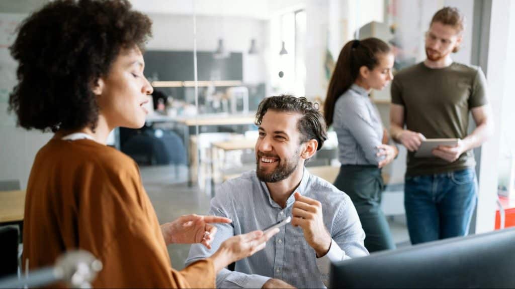 A man making a woman laugh