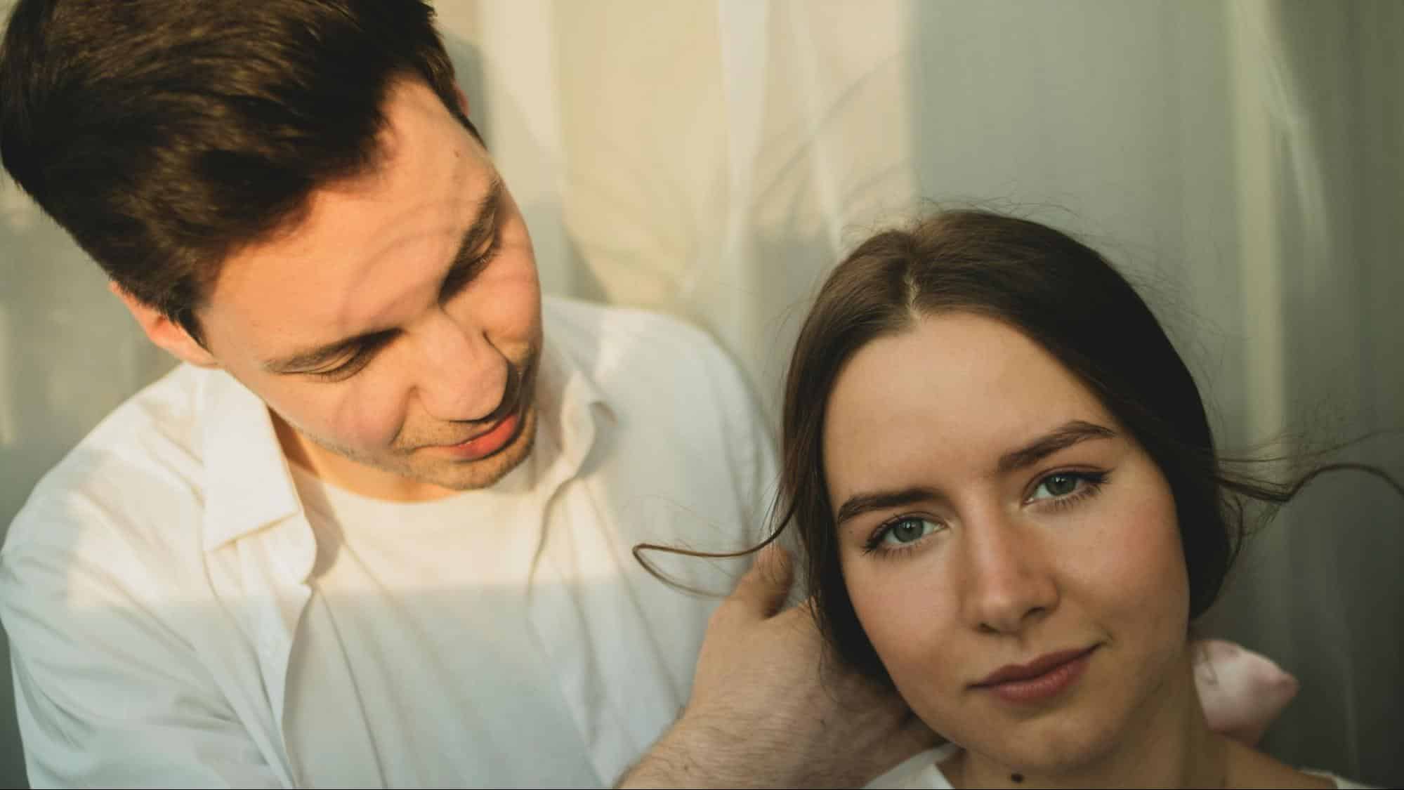 A man fixing woman’s hair