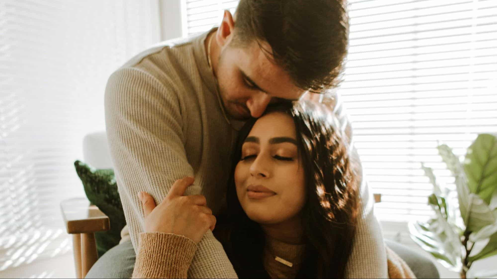 A man embracing woman