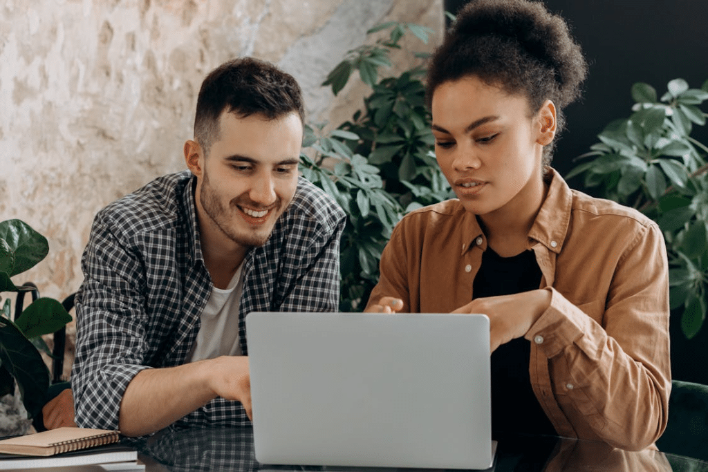 A Man and Woman Using a Laptop Together
