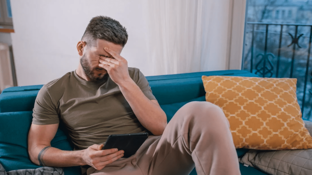 A man looking upset at home