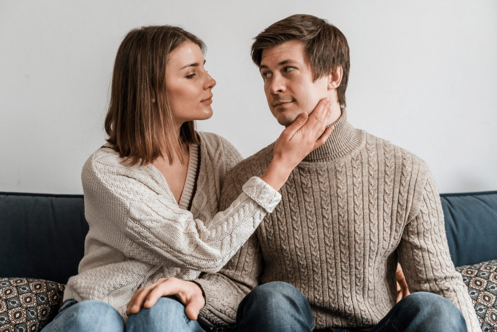Woman holding man’s face