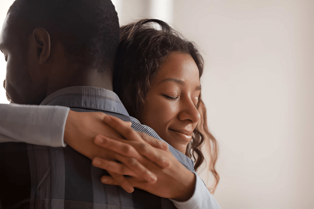 Closeup of wife embracing husband