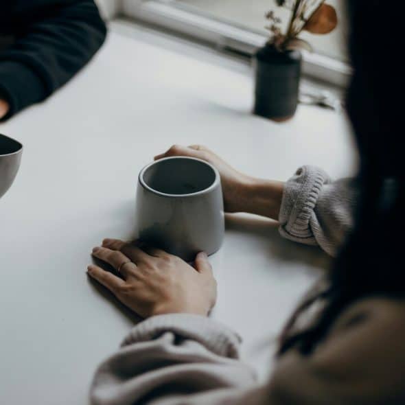 A couple talking over coffee