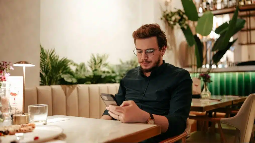 A man alone and using a phone
