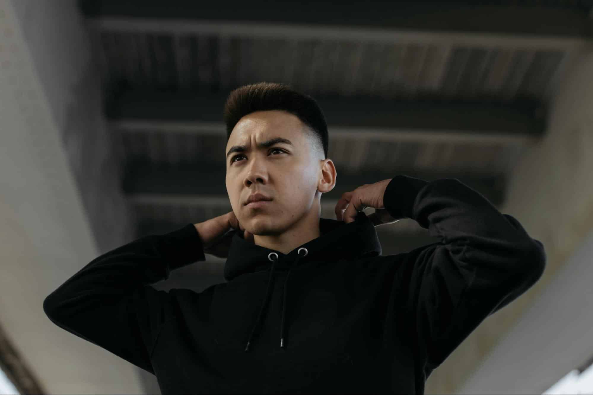 A man wearing a black hoodie.