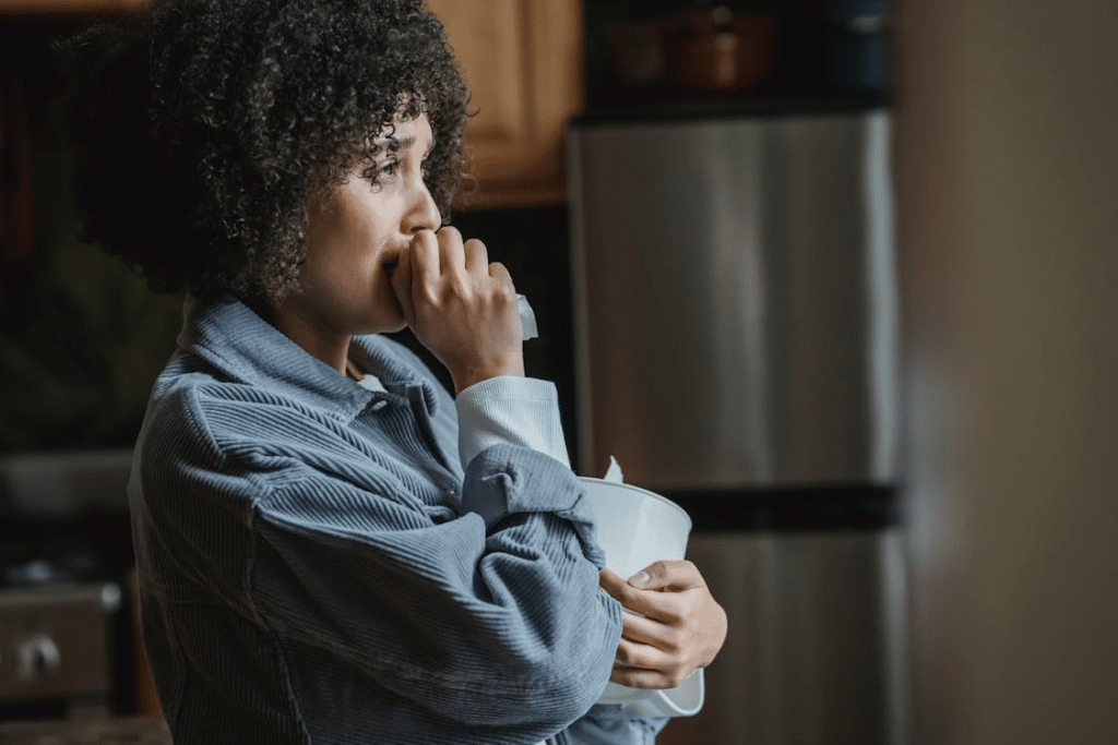 Upset woman crying staring out window