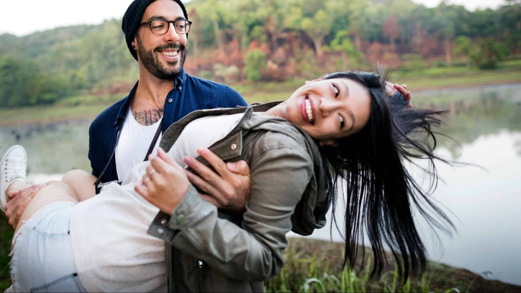 A man carrying woman