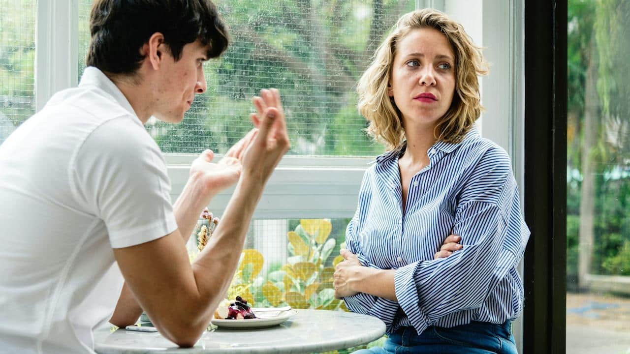 A couple is having an argument at the cafe.