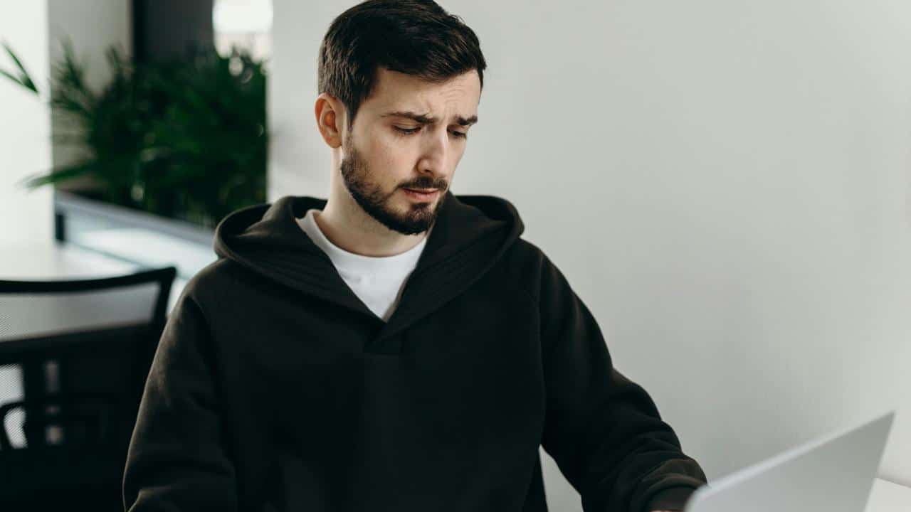A man in a hoodie looking concerned
