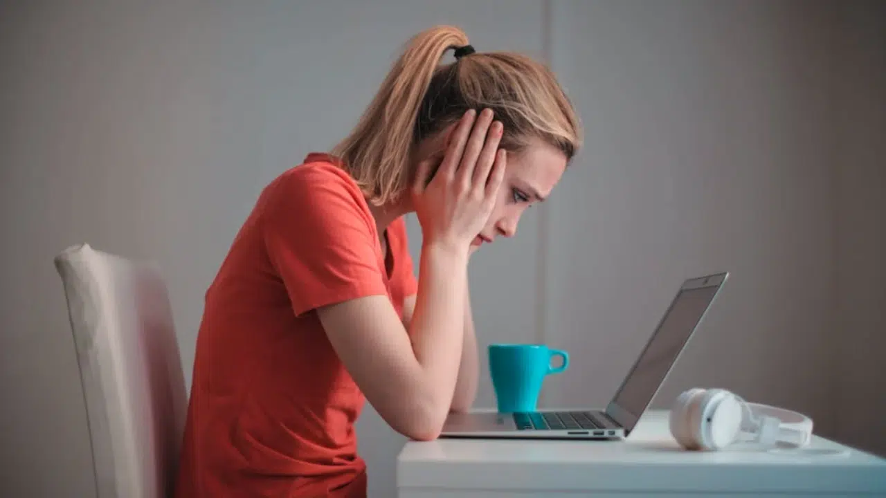 A woman looking devastated at home