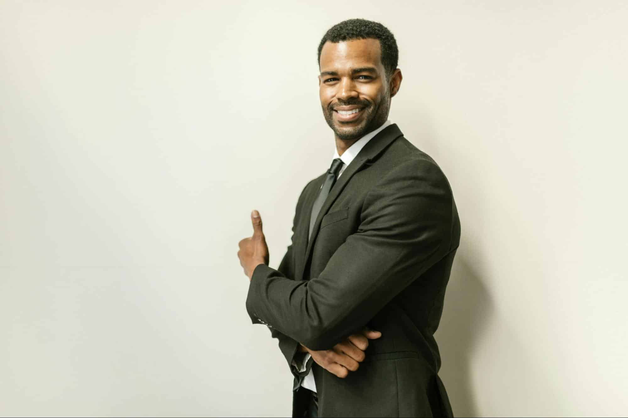 A confident man smiling.