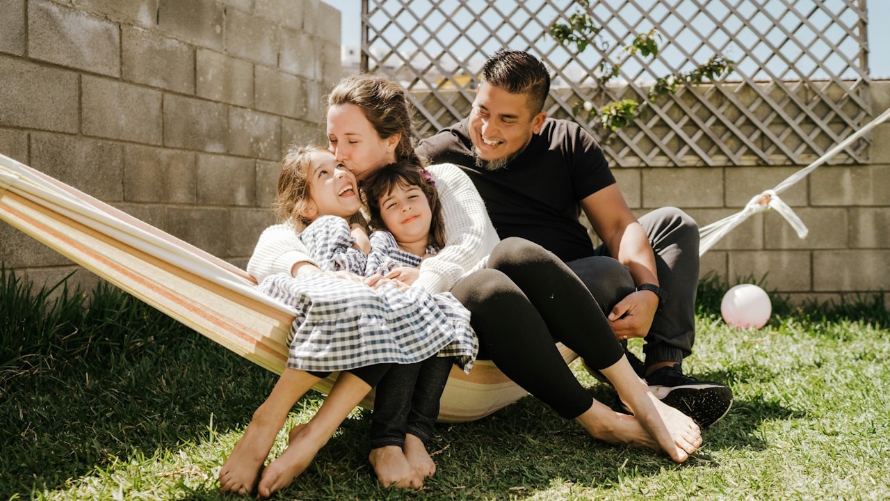 A couple swinging along with their children