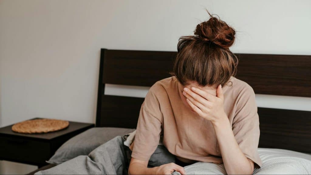 Woman crying while looking at the phone
