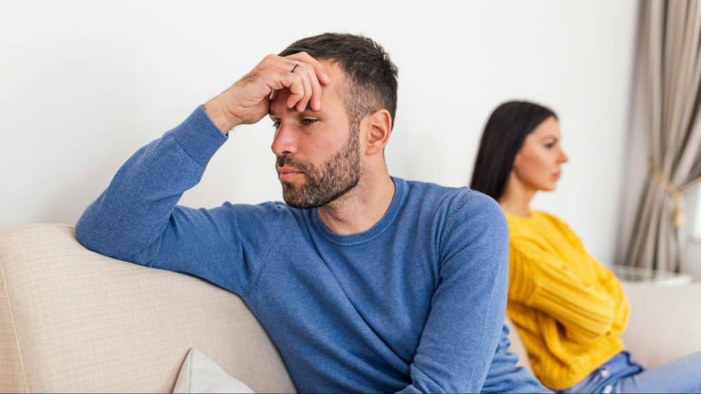 A man thinking while woman behind him