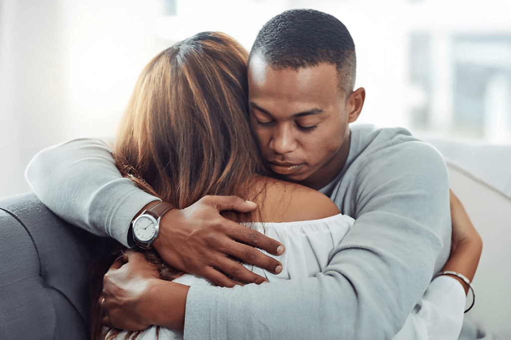 Supportive husband hugging wife
