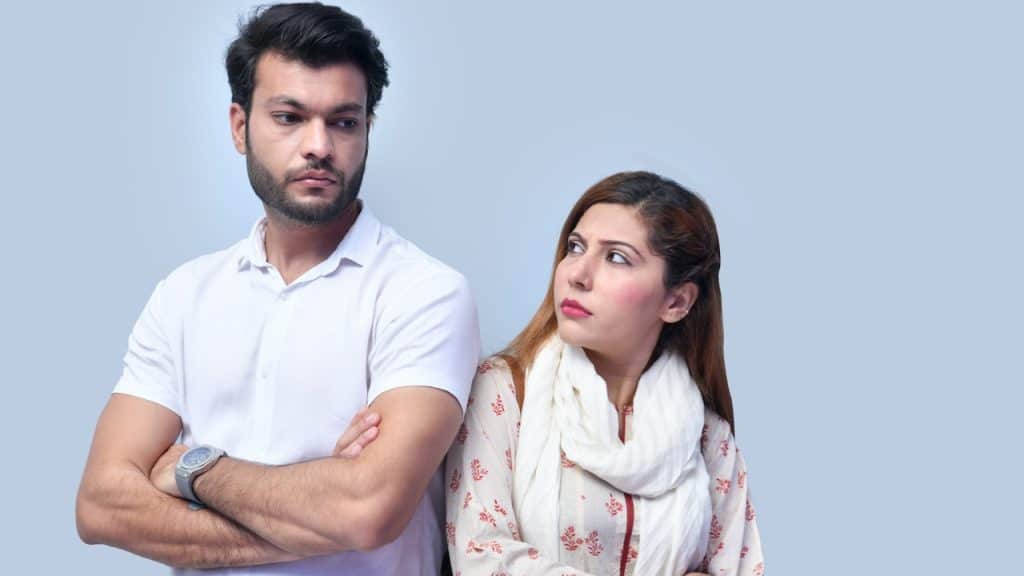 A woman looking at a man standing beside her.