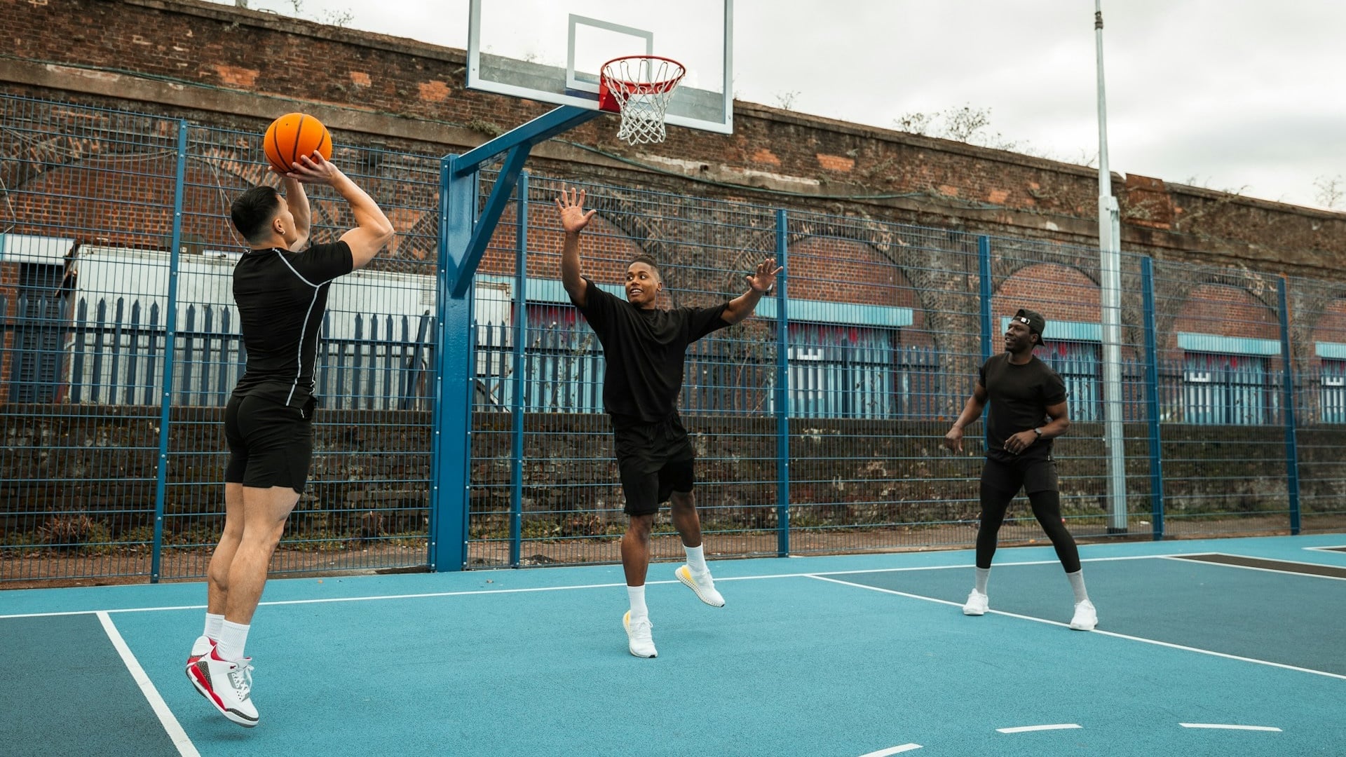 Friends playing basketball.