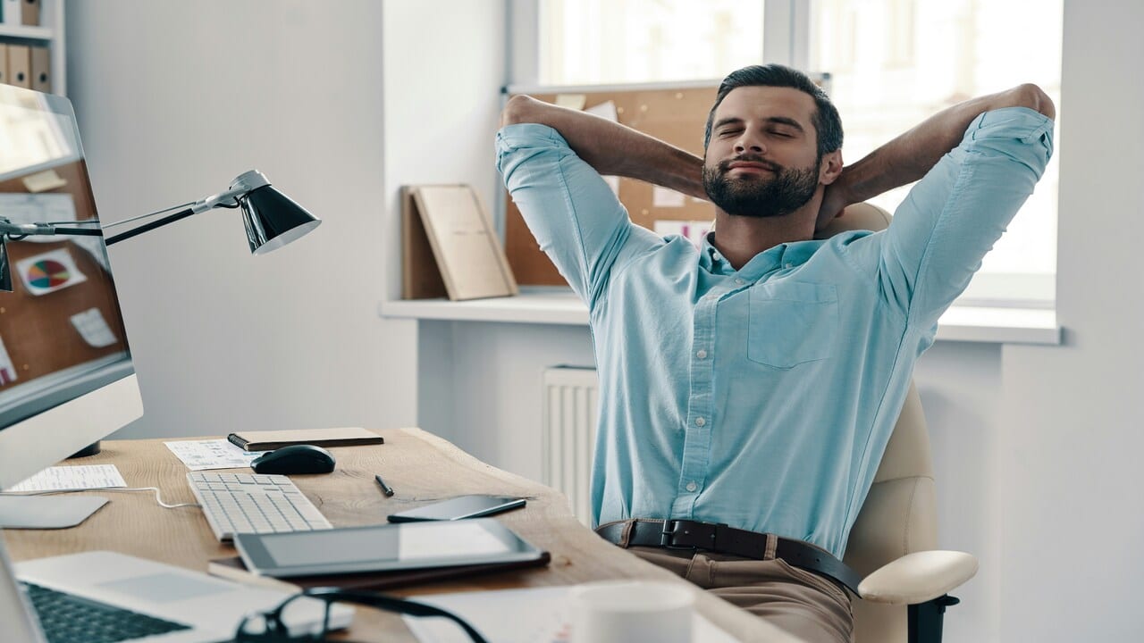 A man closing his eyes while at work