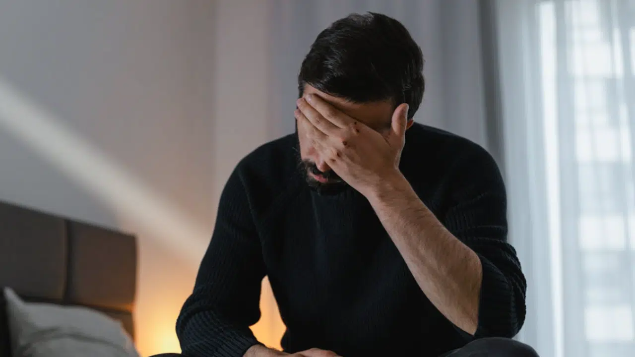 A man looking sad at home