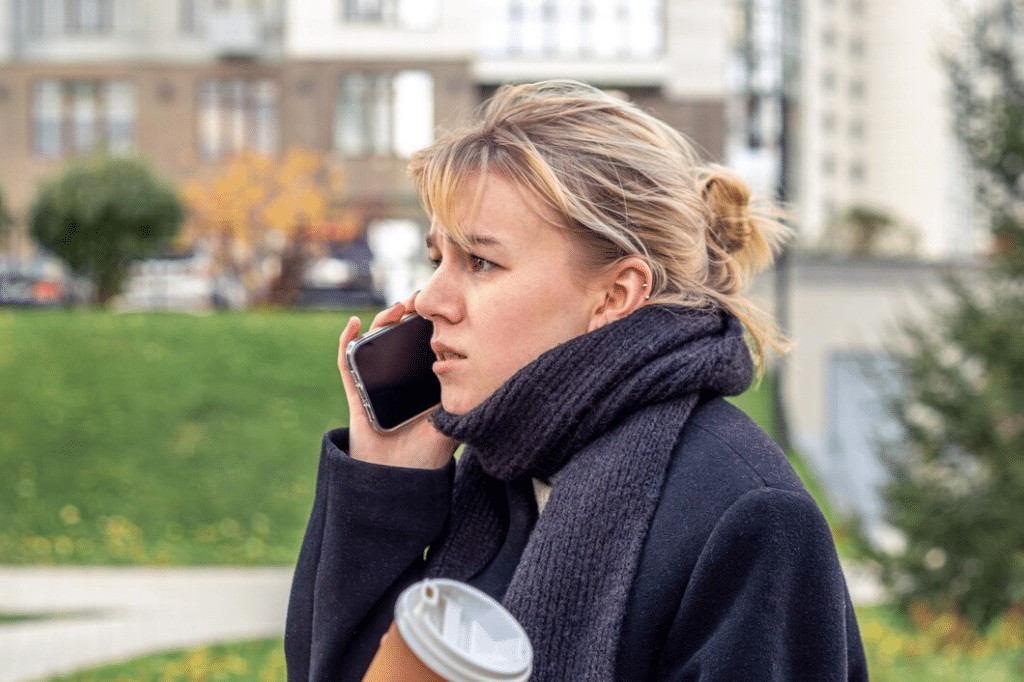 Angry and stressed young woman talking on the phone