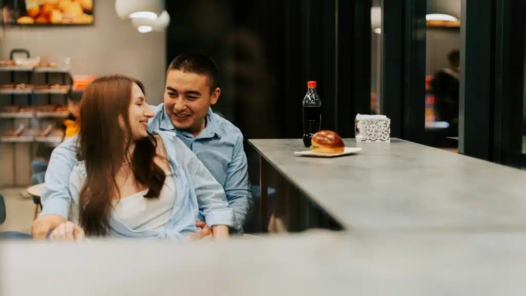 A man and a woman sitting at a counter.