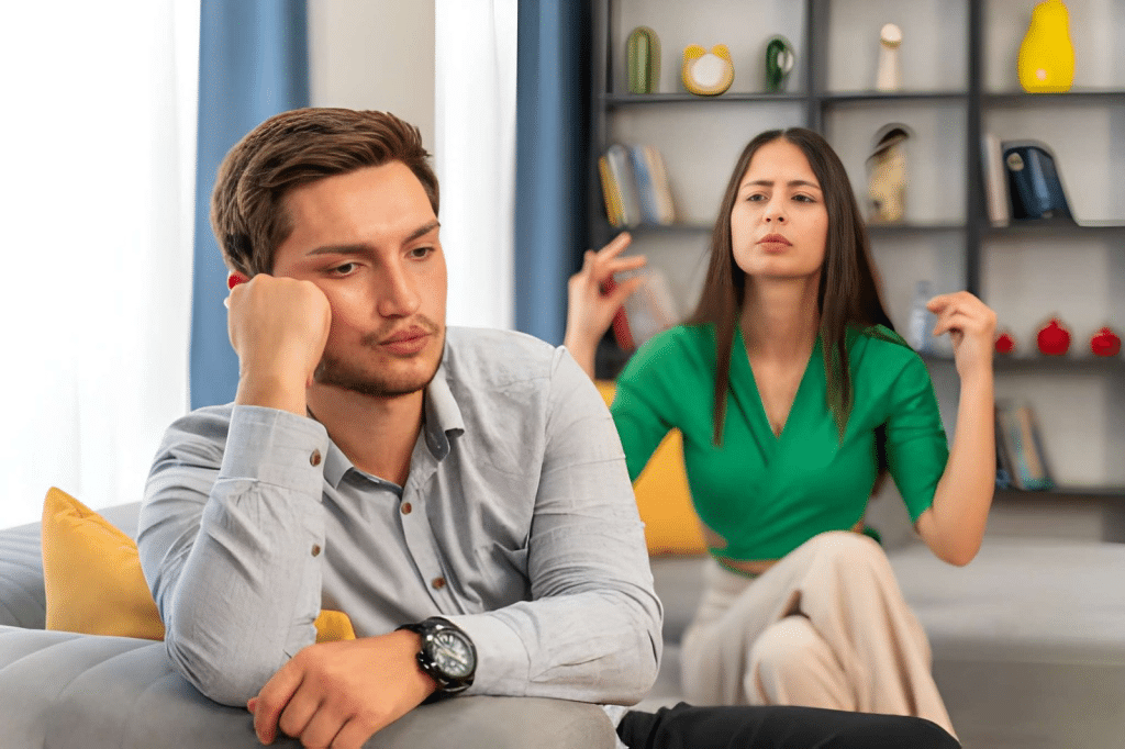 Worried man being ignored by his partner who is chatting online