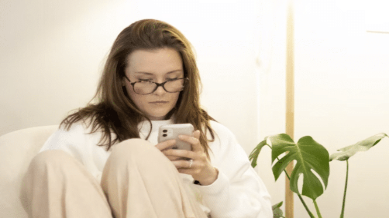A woman looking concerned while texting
