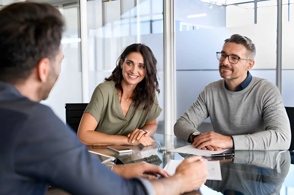Happy couple meeting with financial advisor