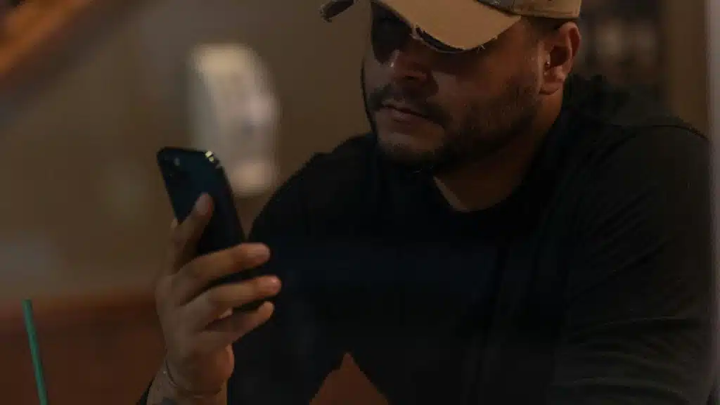 A man wearing a cap and sunglasses