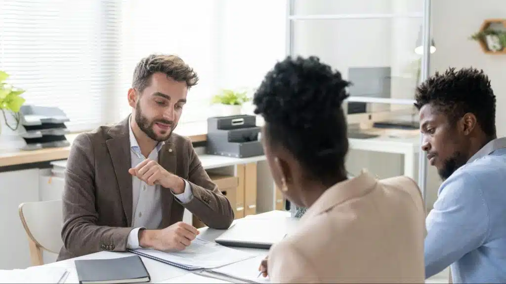 A man and woman talking with their lawyer