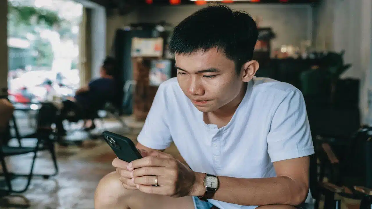 A man looking sad while texting