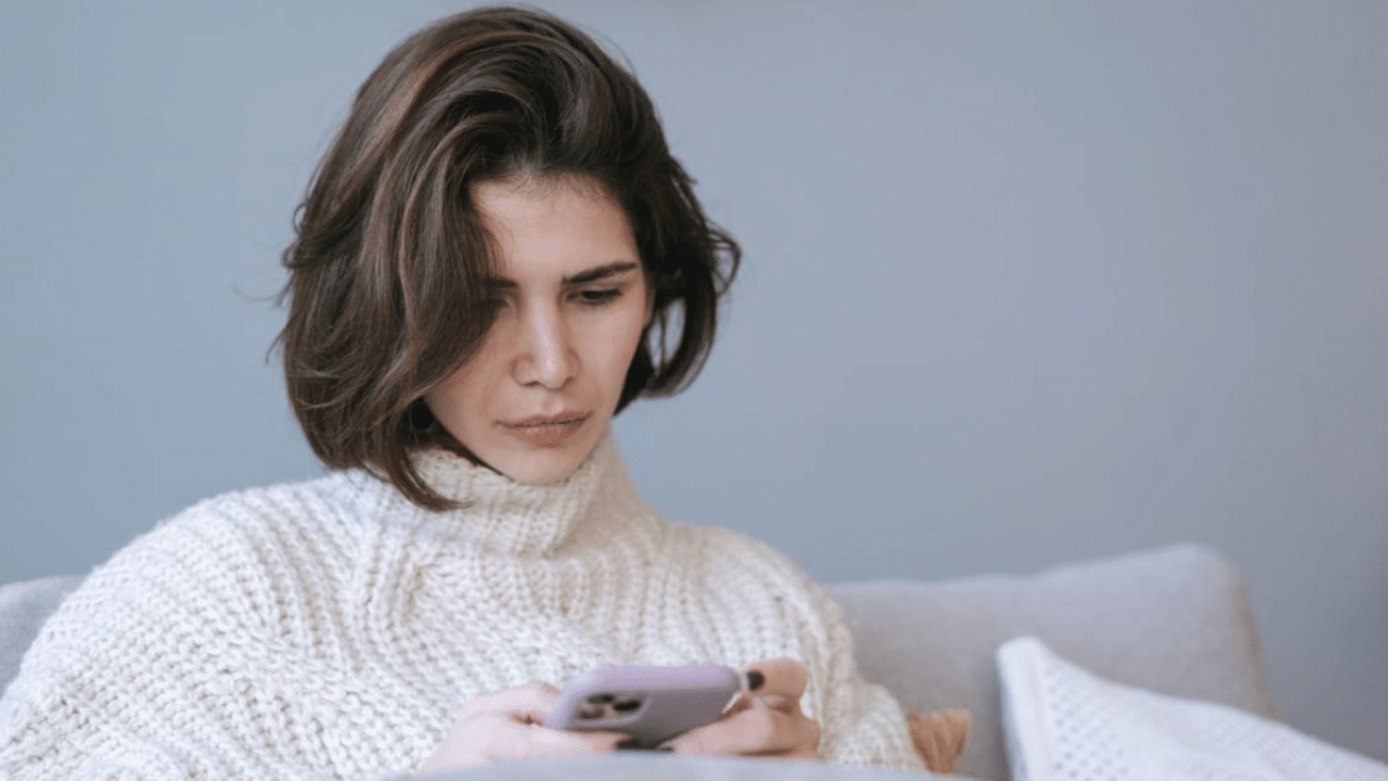 A woman waiting for a text