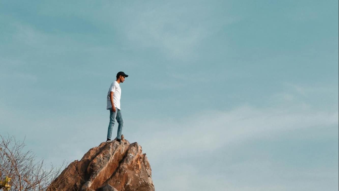 A man standing on a stone.