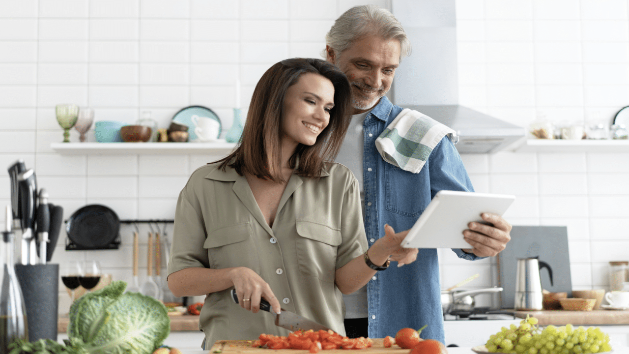 A couple looking at something on a tablet