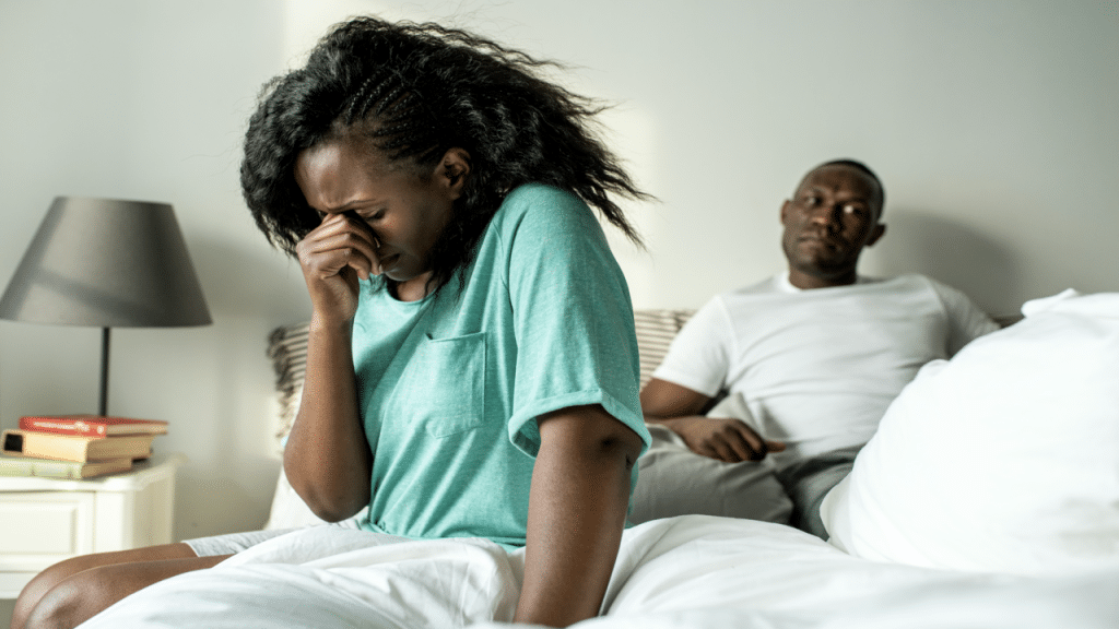 A couple looking upset in the bedroom