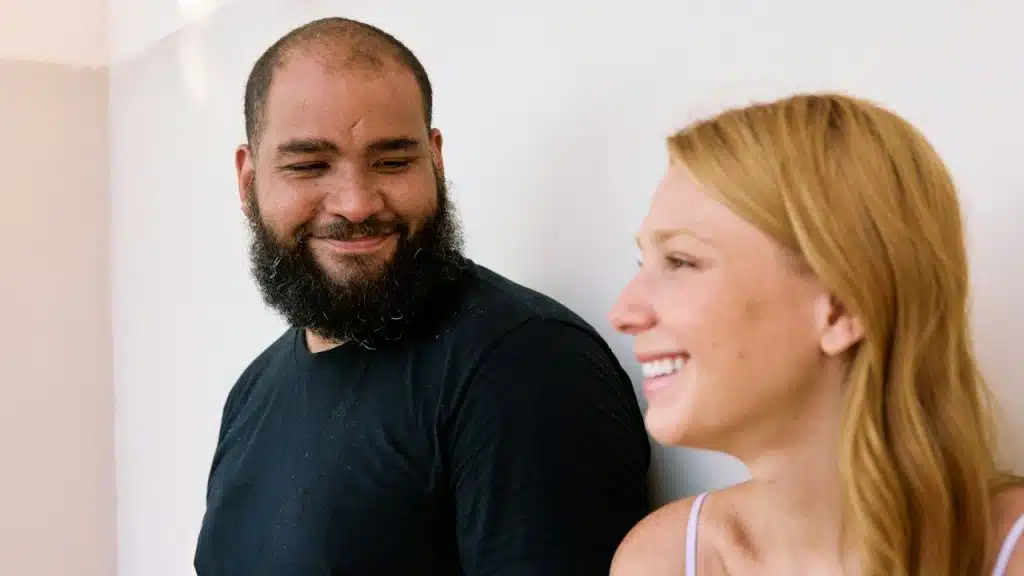 A man with a beard standing next to a woman.