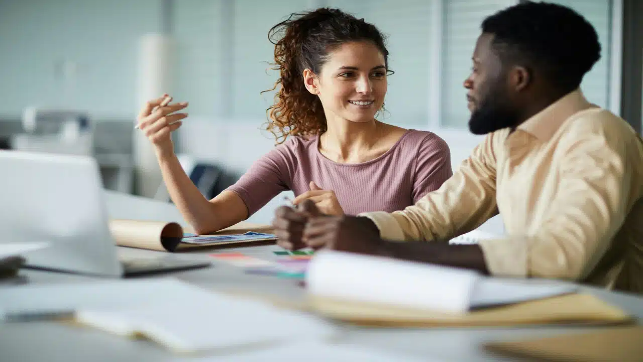 Two colleagues talking at work