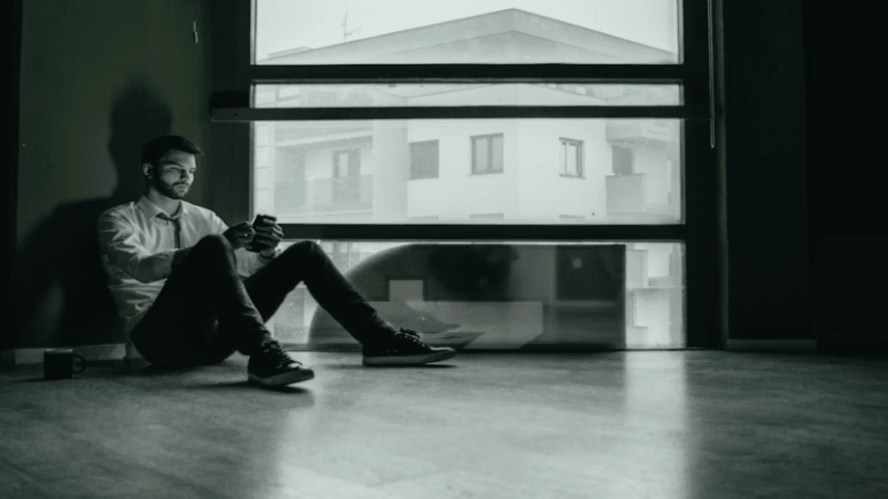 A man looking sad while scrolling