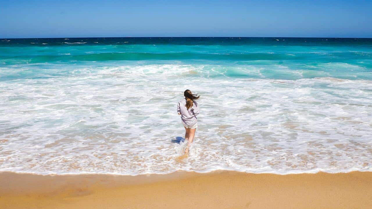 A woman standing on the shore