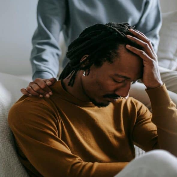 A woman comforting her sad husband
