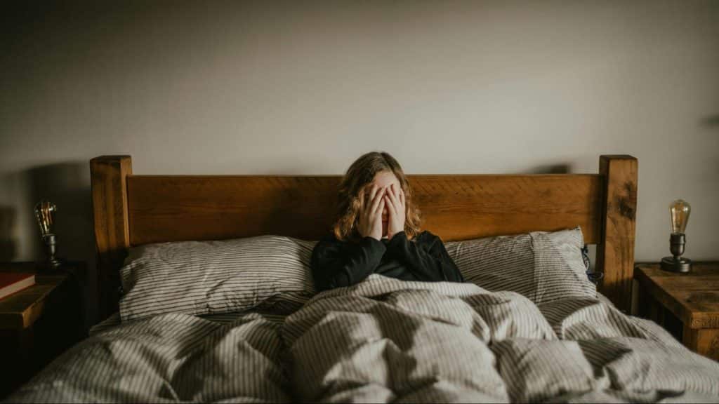 A woman sitting at the bed