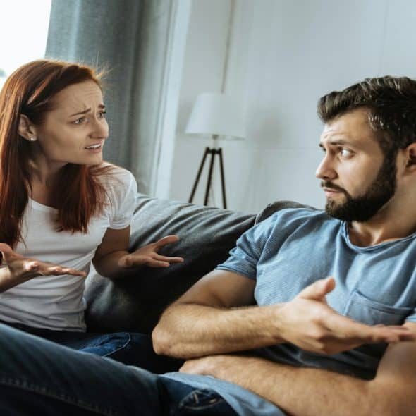 couple talking while one looks uncertain
