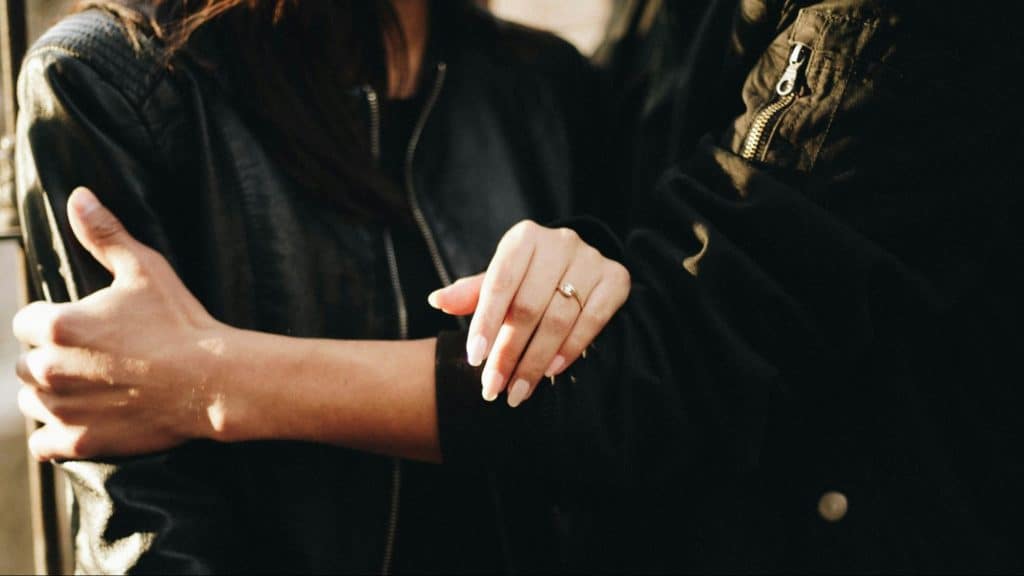 A man holding woman