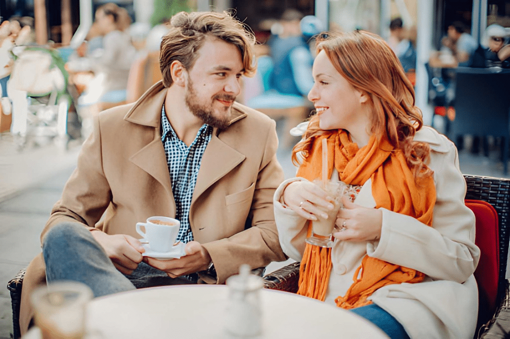 Young couple enjoying at cafe in autumn