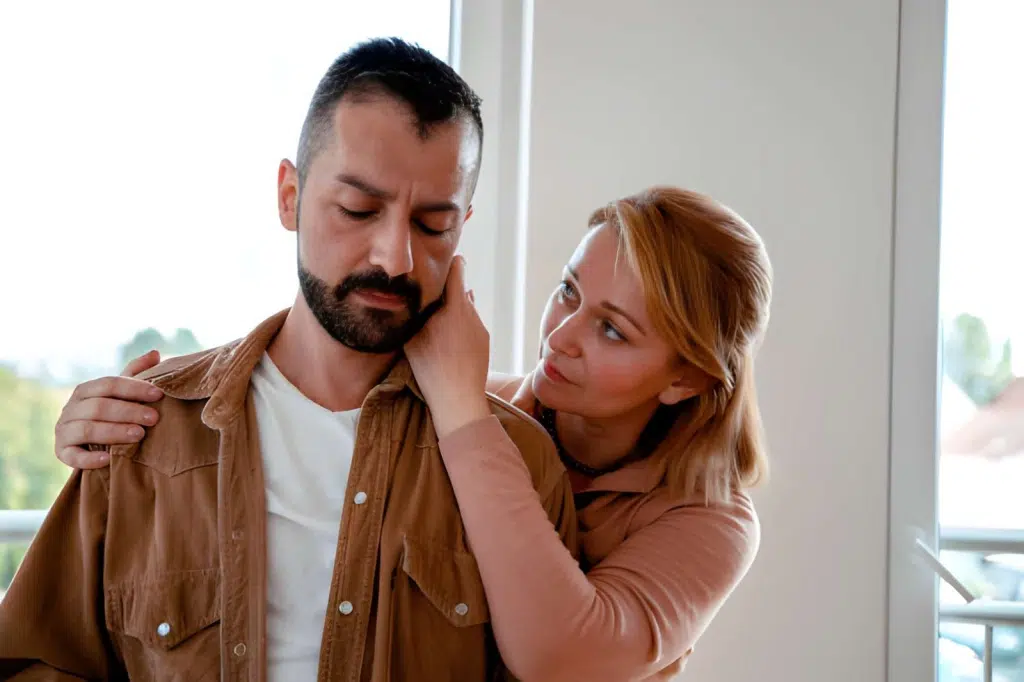 Woman consoling sad husband