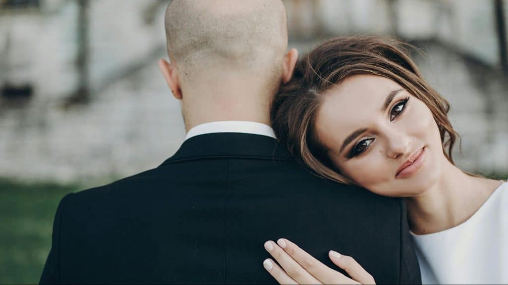 Woman resting her head on a man’s shoulder